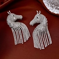 Detailed close-up of horse head earrings with white rhinestones on dark red silk - Silver Pony Tassel (Silver Needle)