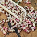 Macro shot of 6x12mm ink-painted bamboo tube beads on a rustic tea scoop for DIY jewelry - Blush Pink (Painted 6x12mm)