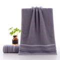 Dark grey cotton towel set with geometric herringbone border in a minimalist home setting - Gradient Stripe Grey / 34*74cm