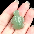 Mini green aventurine turtle crystal carving held in palm to show compact size - Green Aventurine