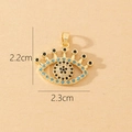 Macro view of gold Evil Eye pendant with blue and white zircon stones sized 2.3cm by 2.2cm - Gold Evil Eye Blue and White Painted Pendant (B)