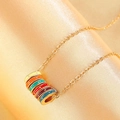 Detail of vintage colorful enamel rings on a gold chain over gold satin fabric background - KC Gold Necklace (Copper/Rainbow Enamel) (N-688) / Gold