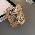 Detailed view of the hollow woven metal texture on a gold wide minimalist bracelet - Gold Hollow Woven Texture Style