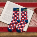 Classic red argyle crew socks with Nice text detail on a vintage book background - Nice