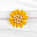 Macro detail of yellow daisy brooch featuring enamel petals and a sparkling rhinestone center - Yellow Rhinestone Daisy