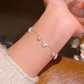 Elegant silver pearl bracelet featuring a butterfly charm and zircon heart on a fine chain - S699 Pearl
