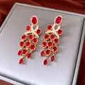 Detail of vintage gold earrings featuring red pear-cut gems and elegant zircon tassels - Silver Earring Post-Gold-Red