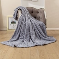 Dark gray flannel blanket with 3D embossed weave texture draped over a velvet chair - Blue Gray