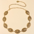 Macro shot of gold metal waist chain featuring embossed bull skull charms on linked medallions - Bull Head Relief Style / Antique Gold (19383)
