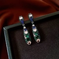 Detailed close-up of vintage drop earrings with multi-colored crystals on a black jewelry box - Silver Needle - Gun Black - Green