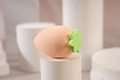 Peach-shaped makeup sponge egg with green leaf detail on white display stand - Pink Peach
