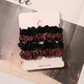 Detailed view of 4-piece satin scrunchies set in black and coffee brown on display card - Black and Coffee