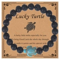 Bracelet en perles de lave noire avec breloque tortue turquoise sur carte cadeau - Pierre de lave