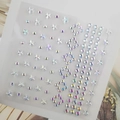 Macro detail of iridescent AB star and round face gems on a clear plastic sheet - BJA-301 (AB Color Five-pointed Star)