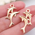 Pair of gold dolphin charms for DIY jewelry making and ocean themed accessories - Dolphin Pendant 17x28mm