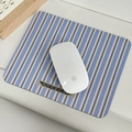 Striped fabric mouse pad with vintage tag on minimalist office desktop setup - Clear Sky Stripes
