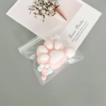 Pink and white cat paw plush in transparent EVA self-sealing bag on a desk - Transparent EVA (15*15CM)