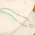 Natural stone necklace with turquoise beads, pearls, and an evil eye pendant on white fabric - Turquoise Evil Eye Style (2# Natural Stone)