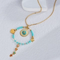 Bohemian gold necklace with turquoise beads, heart and star pendants on white background - Blue
