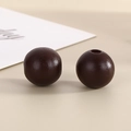 Macro shot of 16mm dark brown wooden round beads with pre-drilled holes for DIY jewelry - Deep Coffee