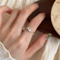 Silver enamel butterfly ring with translucent white moonstone on hand - Moonstone Texture