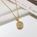 Macro view of gold titanium necklace featuring a double heart circular pendant with rhinestones - Heart-to-Heart