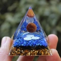 Orgone pyramid with blue gravel, gold foil, and red sphere in clear resin - Tiger Eye Lapis Lazuli / Small