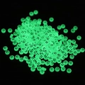 Macro detail of round green luminous letter U beads for DIY handmade jewelry crafts - Letter U / Luminous Green
