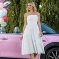 Detail view of 3D floral appliques on a white midi slip dress beside a vintage pink car - XS