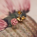 Macro shot of pink enamel rose earrings with gold edges and pavé set leaf accents - Rose Pink Stud Earrings