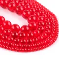 Close-up of vibrant red translucent round glass beads in various sizes for DIY jewelry - Red Glass Beads