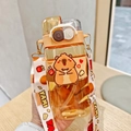 Close-up of clear plastic water bottle with cute guinea pig graphics and adjustable strap - 520ml / 2058 Brown Capybara