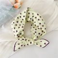 Pale yellow cotton linen scarf with deep purple heart patterns tied in a decorative knot - Little Heart Yellow
