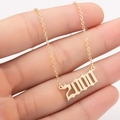 Detailed shot of gold-plated year 2000 pendant on a dainty link chain for women - 2000 / Gold