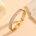 Detailed close-up of golden wavy bracelet with white zircon stones on stone and silk - Gold Wave Pattern Style (M811)
