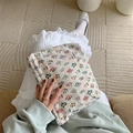 Floral cotton pouch held by a model, showing white fabric with delicate flower patterns - Floral Rhombus