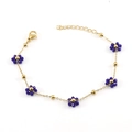 Golden stainless steel chain bracelet featuring multiple blue beaded flower charms - Blue Bracelet