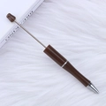 DIY beaded pen in coffee and silver finish on a soft white plush background - Silk Fog Brown
