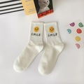 White cotton mid-calf socks featuring a yellow smiley face and bold SMILE lettering - One Size / Smile Text Smiley