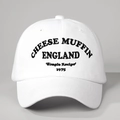 White cotton baseball cap with black Cheese Muffin England 1975 embroidery and adjustable strap - One Size / White