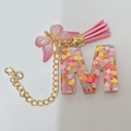 Letter M resin keychain with colorful heart glitter, pink tassel and butterfly charm - Letter M