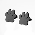 Close-up of minimalist black paw print stud earrings with a matte metallic finish - 104 Paw - Black