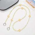 Detail of yellow flower beaded phone strap with metal rings on white background - Yellow