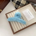 Macro detail of a light blue plush hair claw clip showing the soft and fuzzy texture - L / Creamy Blue