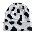 Detailed flat lay view of a black and white cow print knitted beanie with wool texture - Cow Print - White