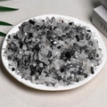Mix of clear and opaque black and white natural crystal crushed stones in a round plate - Black Rutilated Quartz (5-7mm) 100g