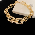 Gros plan d'un collier à grosses mailles dorées avec fermoir mousqueton et détails - Collier à Grosses Mailles / Doré