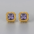 Macro detail of square purple zircon earrings with a golden halo setting and white stones - Gold Purple
