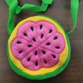 Detail view of a plush round watermelon slice crossbody bag for kids with pink inner pulp - Pink Watermelon