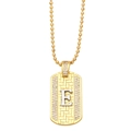 Detailed close-up of golden dog tag pendant with silver letter E and micro-set cubic zirconia - Letter E
